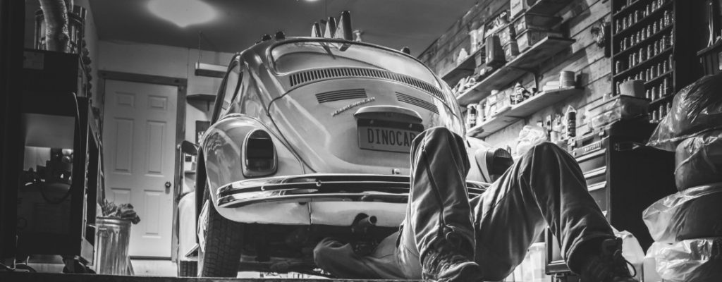 man under car repairing it